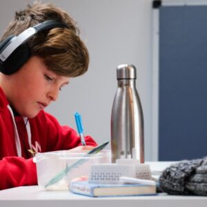 woman in red and white hoodie wearing black headphones
